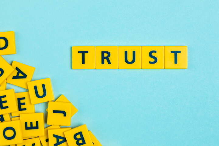 Scrabble tiles spelling, "Trust",
