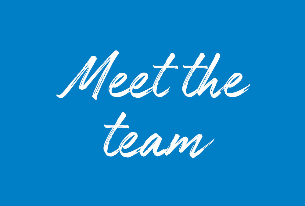 A picture of a blue background with white writing saying, "Meet the team",